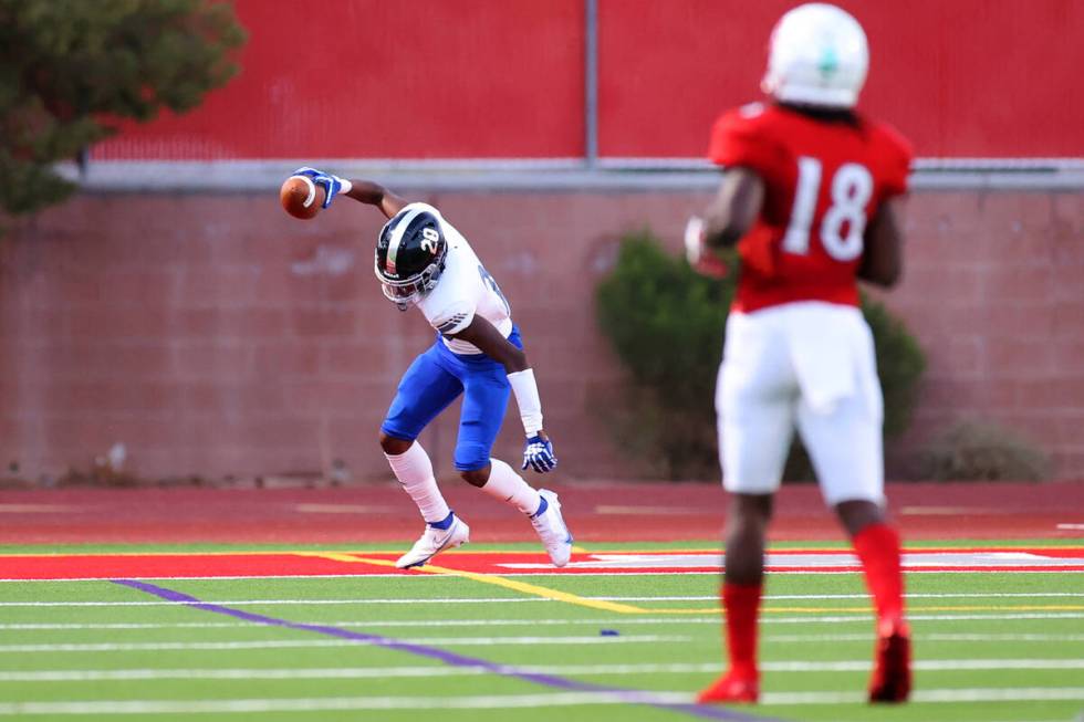 Desert Pines Isaiah Rubin (20) celebrates a touchdown after intercepting the ball in the first ...