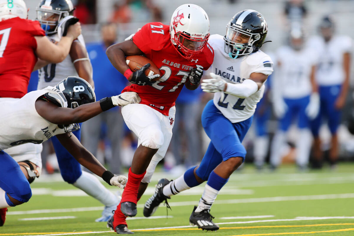 Arbor View's Makhai Donaldson (27) runs the ball before getting tackled by Desert Oasis Labarri ...