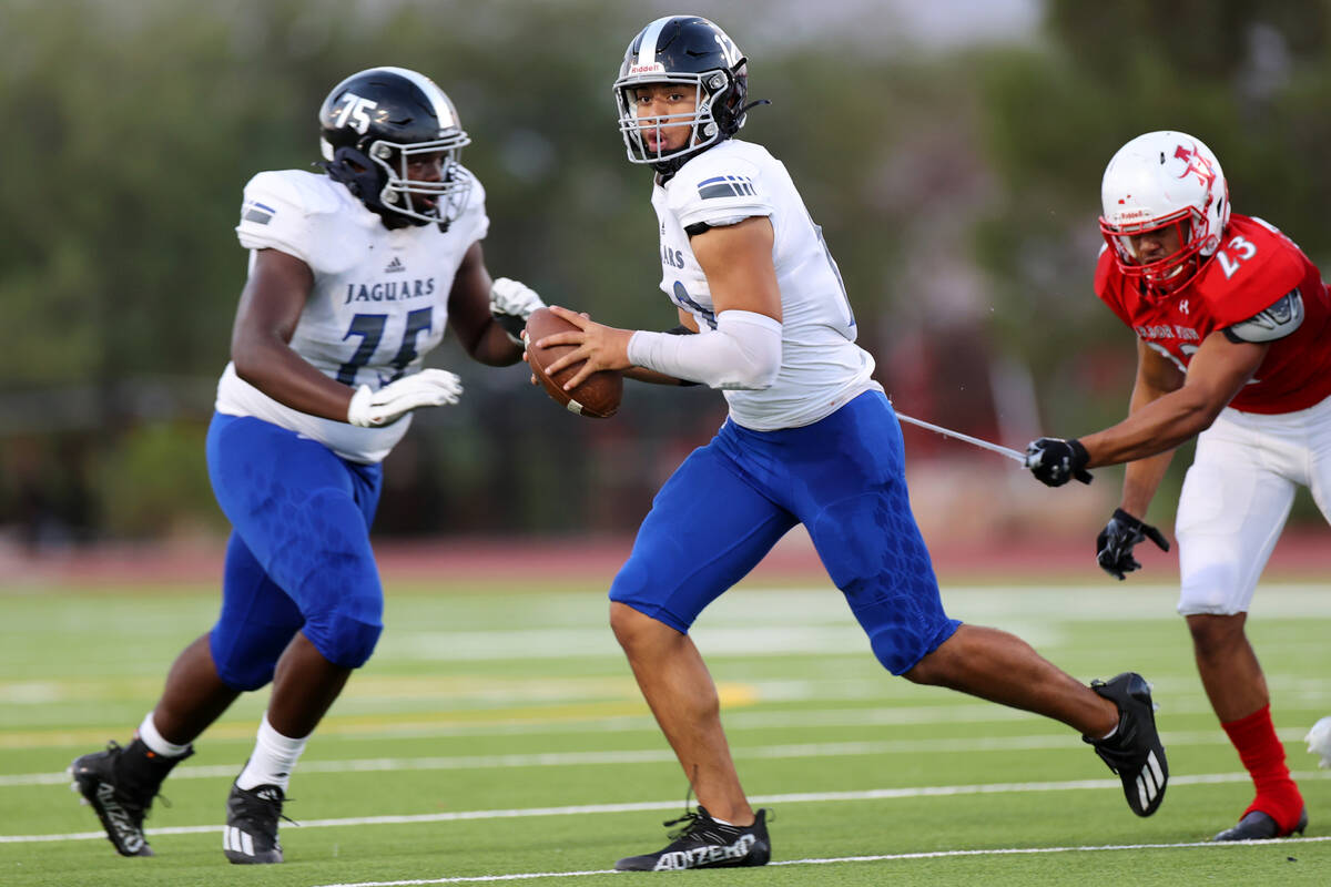 Arbor View's Toa Howard (23) misses a tackle of Desert Pines quarterback Rjay Tagataese (12) in ...