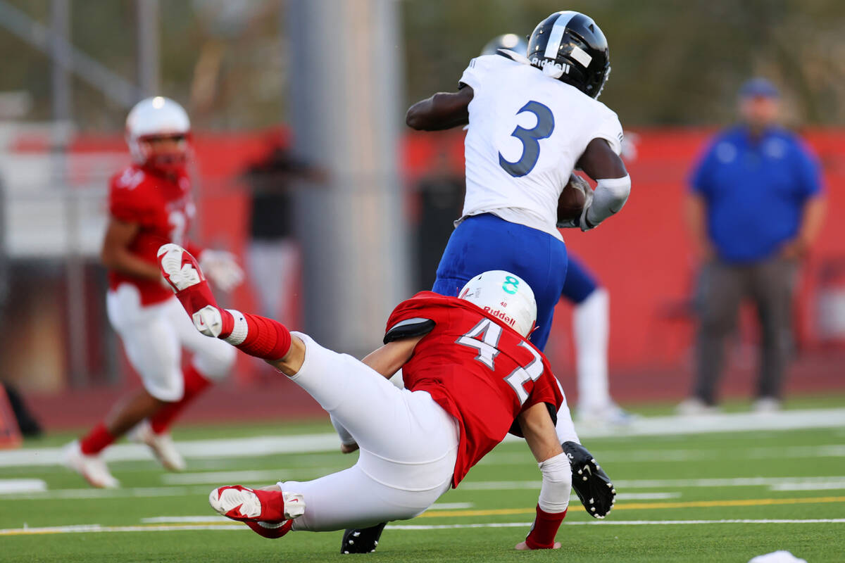 Desert Pines Lavon Brown (3) dodges a tackle against Arbor View's Christian Thatcher (42) befo ...