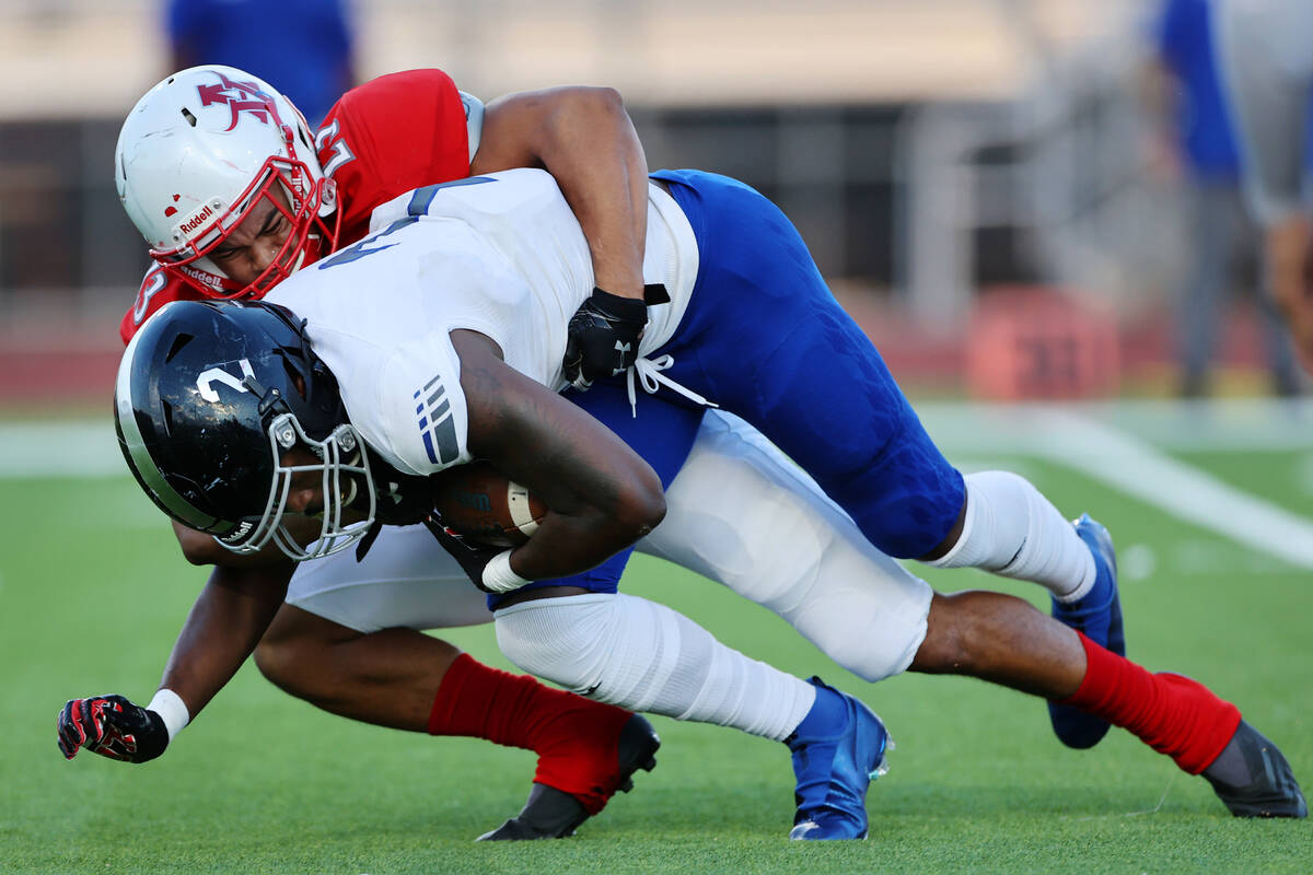 Arbor View's Toa Howard (23) tackles Desert Pines Javontae Barnes (2) in the first half of a fo ...