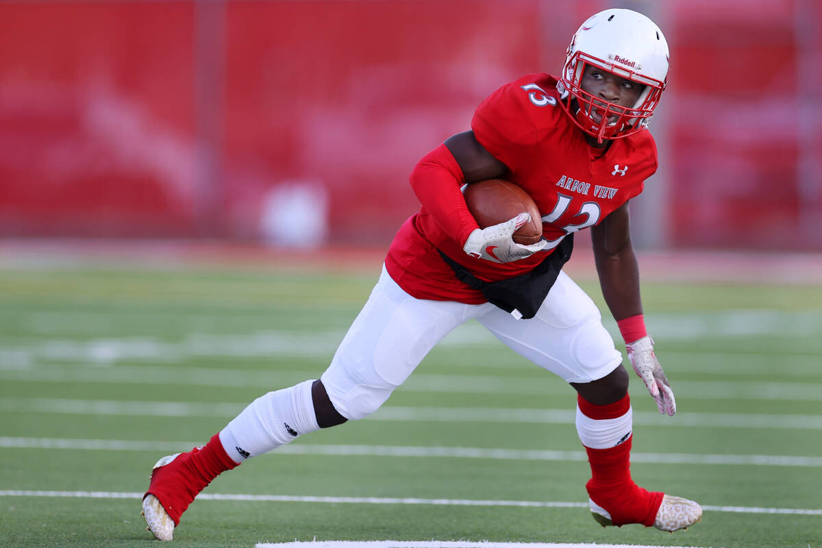 Arbor View's D'Andre Washington (13) runs the ball after a catch in the first half of a footbal ...