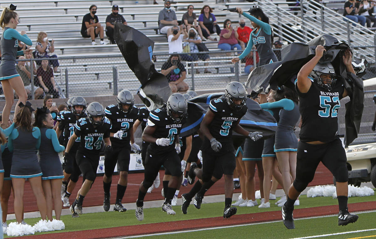 Silverado High School's players run out to the field before the start of a football game again ...