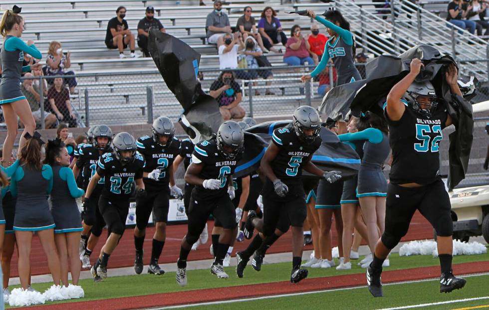 Silverado High School's players run out to the field before the start of a football game again ...