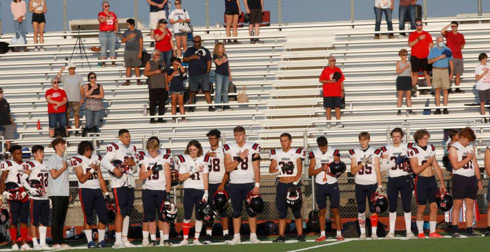 Coronado High School's players stand for the national anthem before a football game against Sil ...