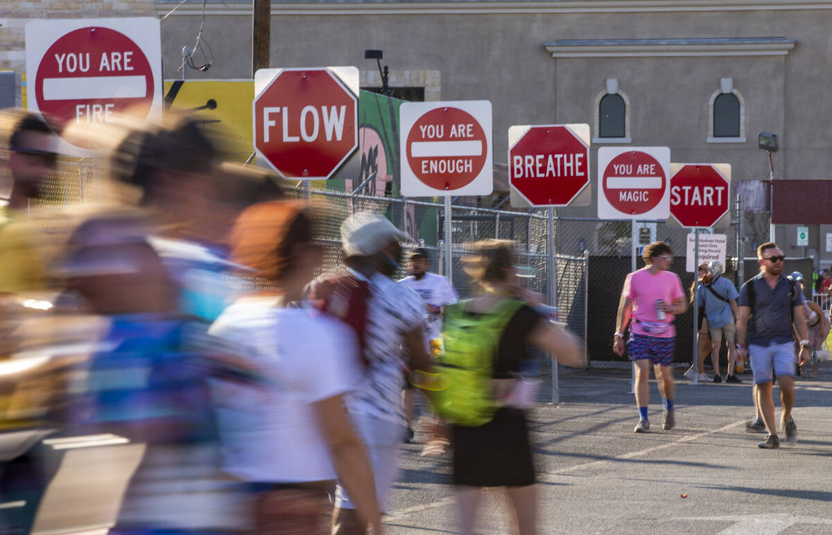 People walk along a sign art display north of Fremont Street during day two of Life is Beautifu ...