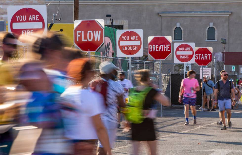 People walk along a sign art display north of Fremont Street during day two of Life is Beautifu ...