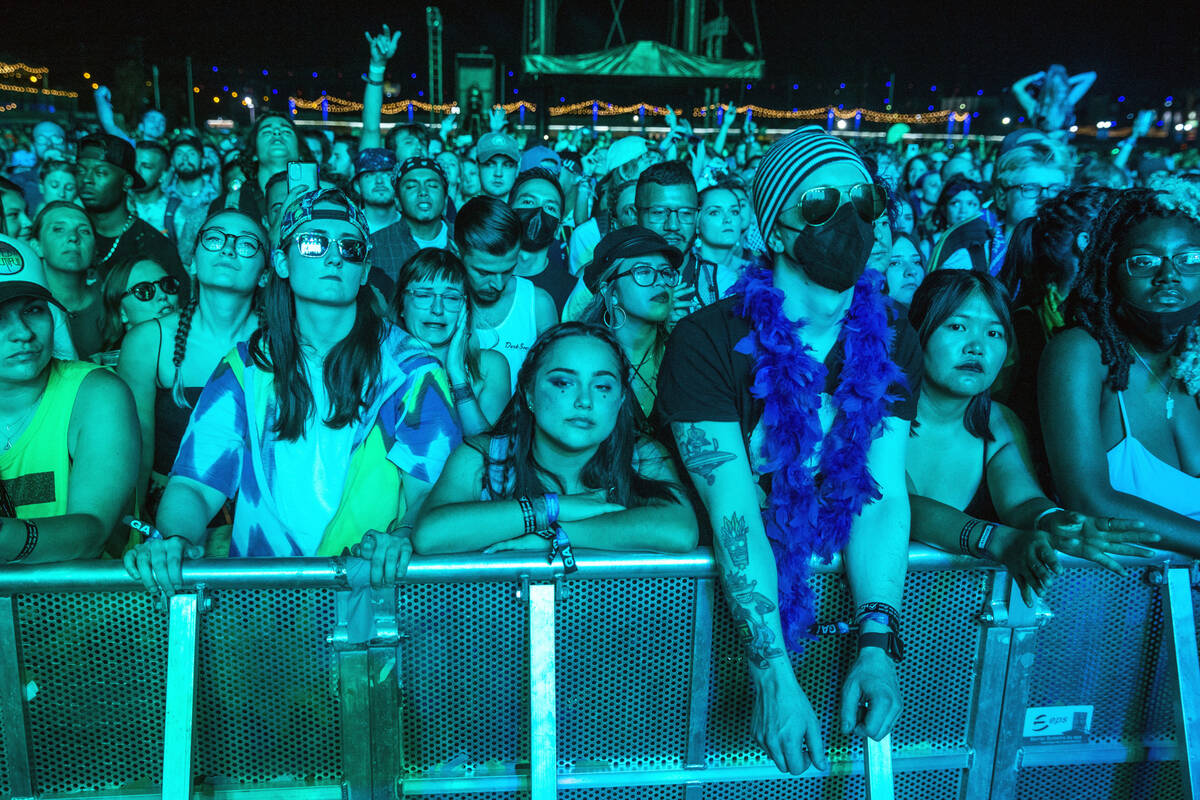 Fans listen while bathed in blue as Modest Mouse performs on the Downtown Stage during day two ...