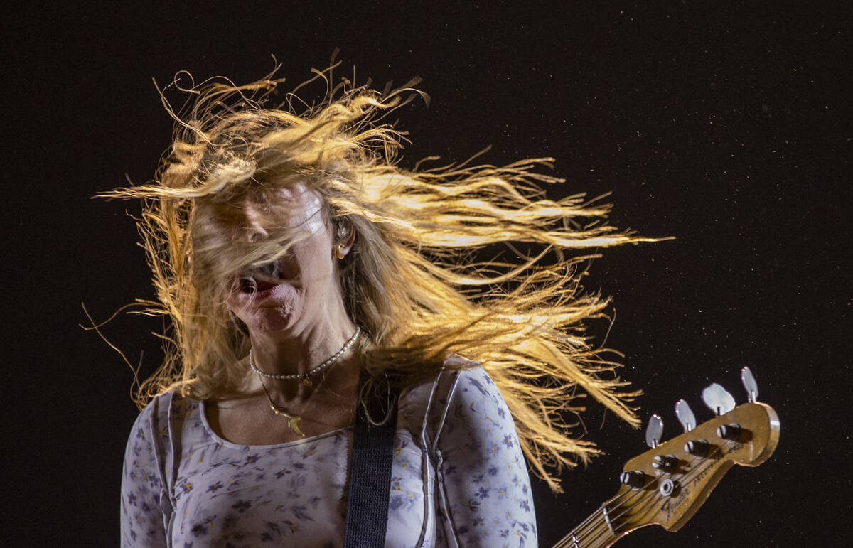 Este Haim plays the bass guitar with family band HAIM on the Downtown Stage during day two of L ...
