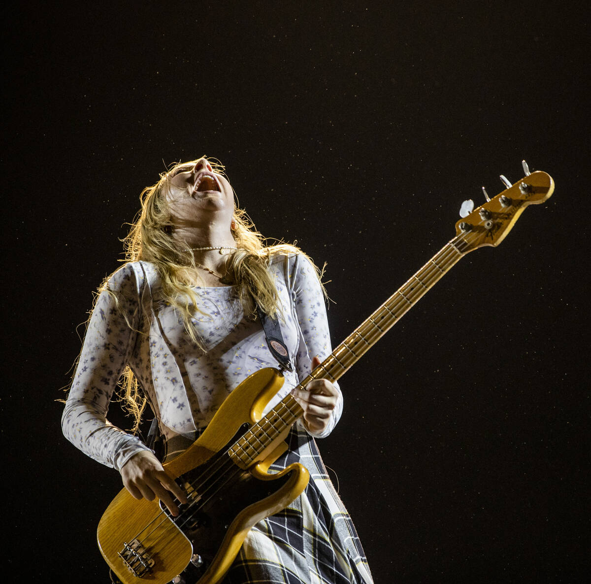 Este Haim plays the bass guitar with family band HAIM on the Downtown Stage during day two of L ...