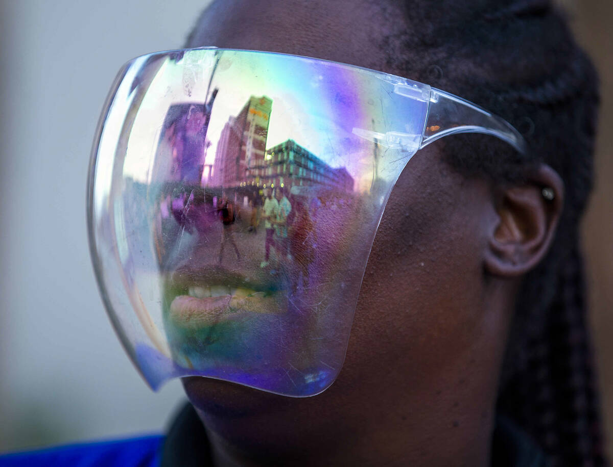 Shelley Ross with CSC Security has attendees reflected in her face shield during day one of Lif ...