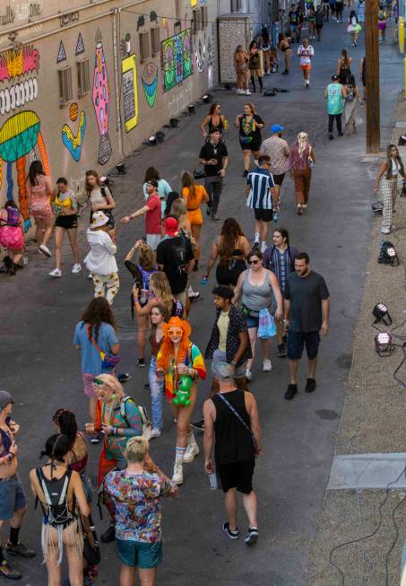 People walk along an alley off of Fremont Street painted with new art during day one of Life is ...