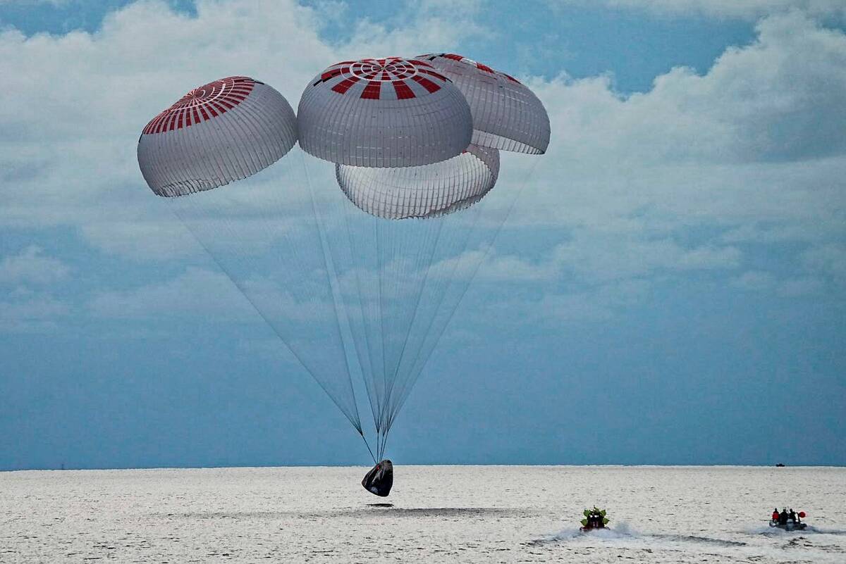 A capsule carrying four people parachutes into the Atlantic Ocean off the Florida coast, Saturd ...
