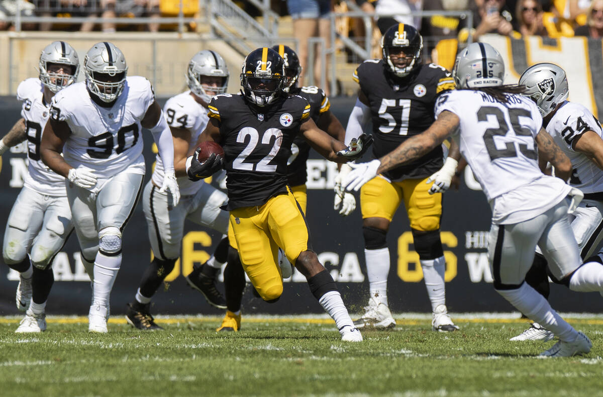 Pittsburgh Steelers running back Najee Harris (22) breaks off a big run past Raiders safety Tre ...