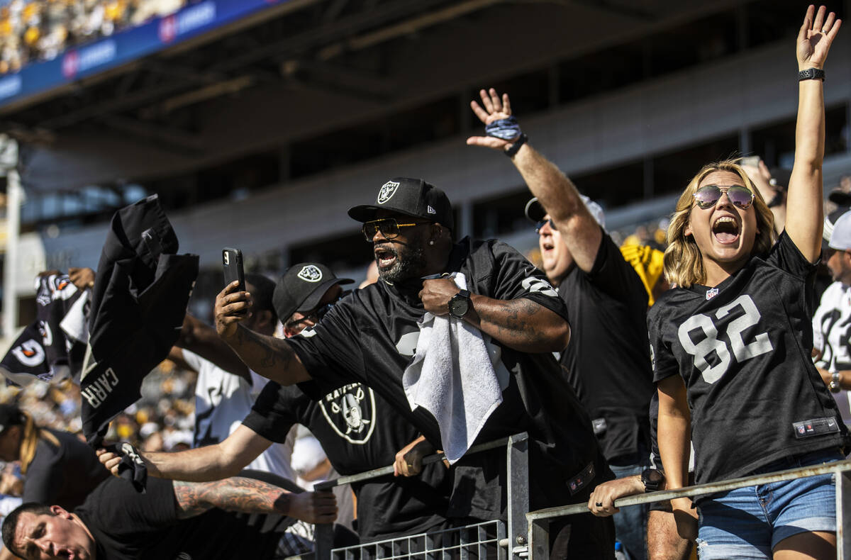 Raiders fans celebrate after beating the Pittsburgh Steelers at Heinz Field during an NFL footb ...