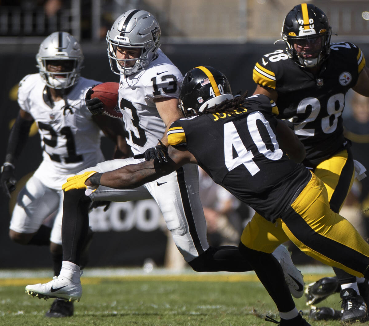 Raiders wide receiver Hunter Renfrow (13) returns a kick past Pittsburgh Steelers linebacker Ja ...