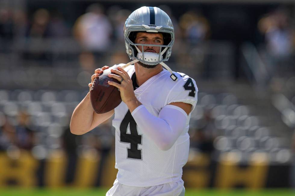 Raiders quarterback Derek Carr (4) warms up before an NFL football game on Sunday, Sept. 19, 20 ...