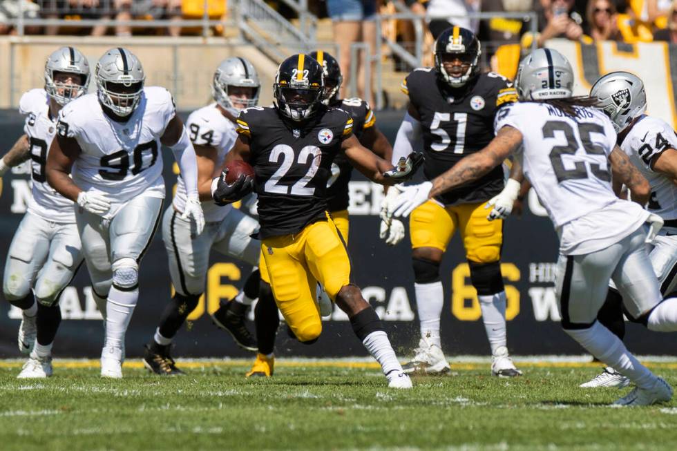 Pittsburgh Steelers running back Najee Harris (22) breaks off a big run past Raiders safety Tre ...