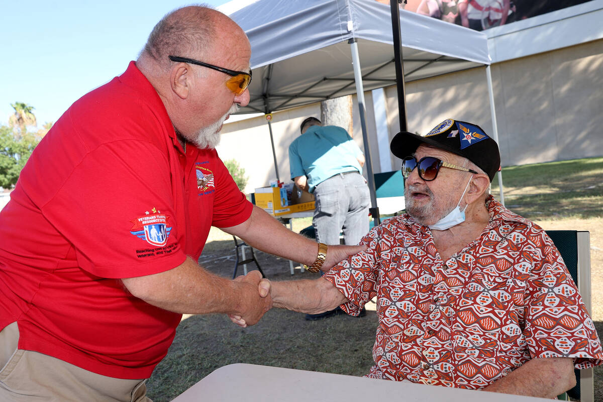 World War II veteran Vincent Shank, right, is congratulated by J.B. Brown on his 105th birthday ...