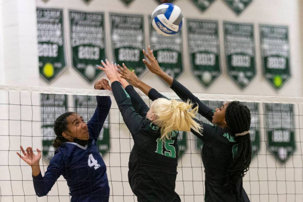 Palo Verde's Rilee Read (15) and Naomi White (8) kill a shot by Shadow Ridge's Moni Jerome (4) ...