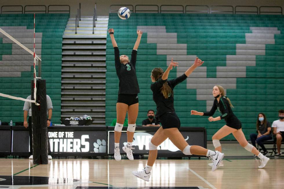 Palo Verde's C.J. Hausler (3) sets as her teammates Lincoln Common, center right, and Kate Camp ...