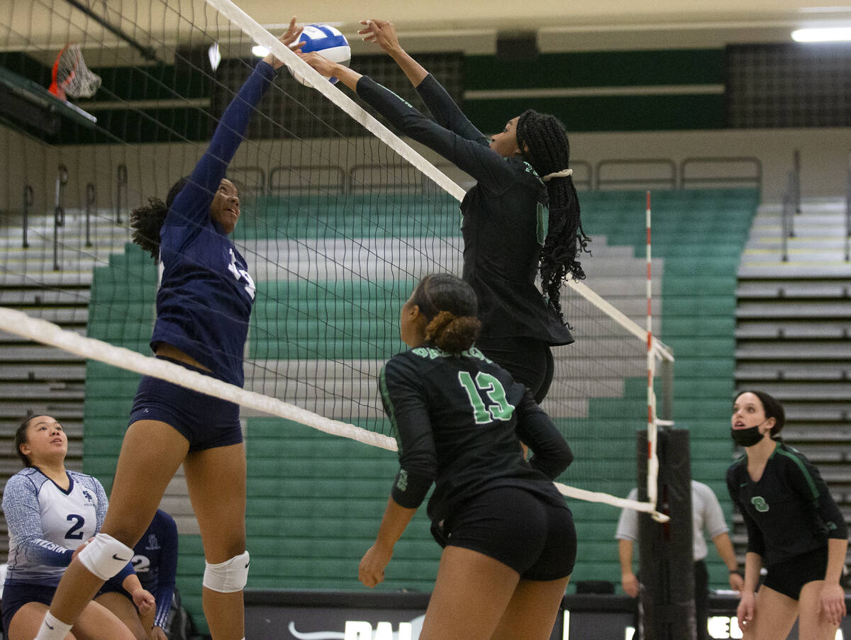 Palo Verde's Naomi White (8) kills a shot by Shadow Ridge's Jyniah Sanders (14) during their hi ...