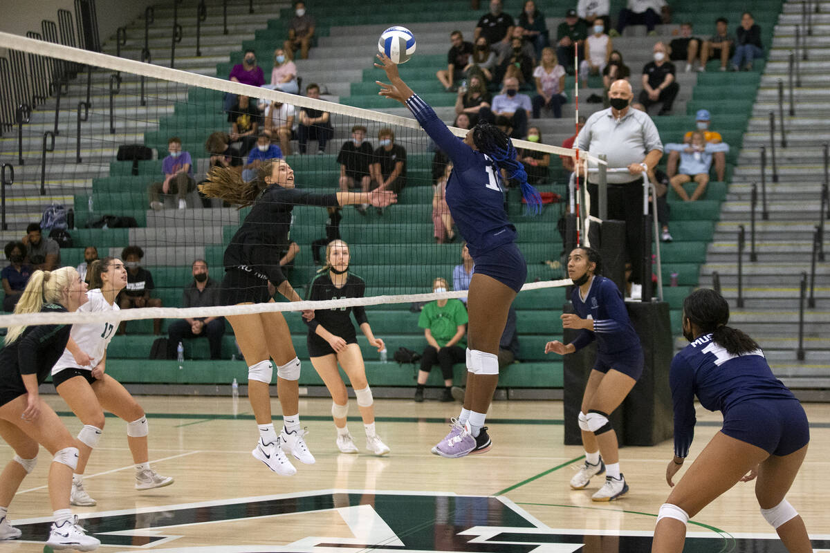 Shadow Ridge's Jocelyn Sanders (16) attempts to kill a spike by Palo Verde's Lincoln Common (9) ...