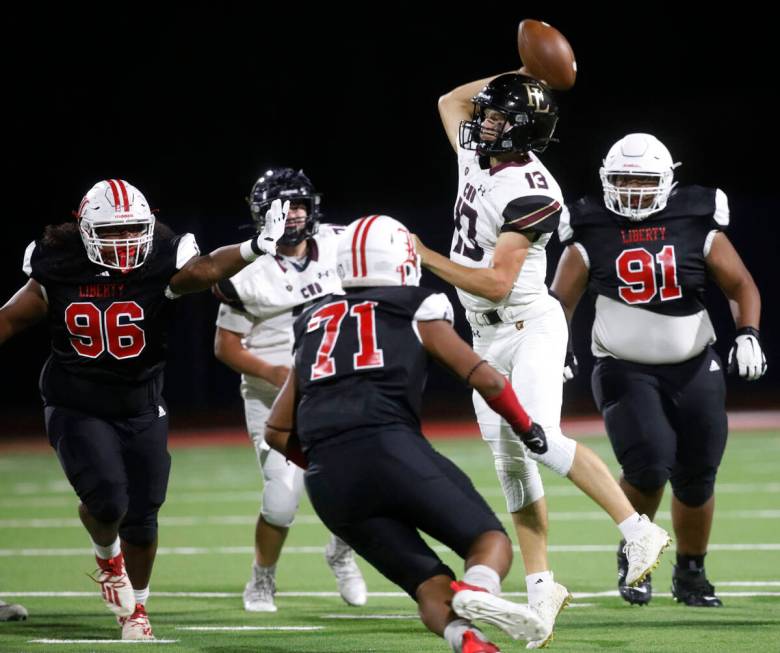 Faith Lutheran High School's quarterback Rylan Walter (13) throws a pass against Liberty High S ...