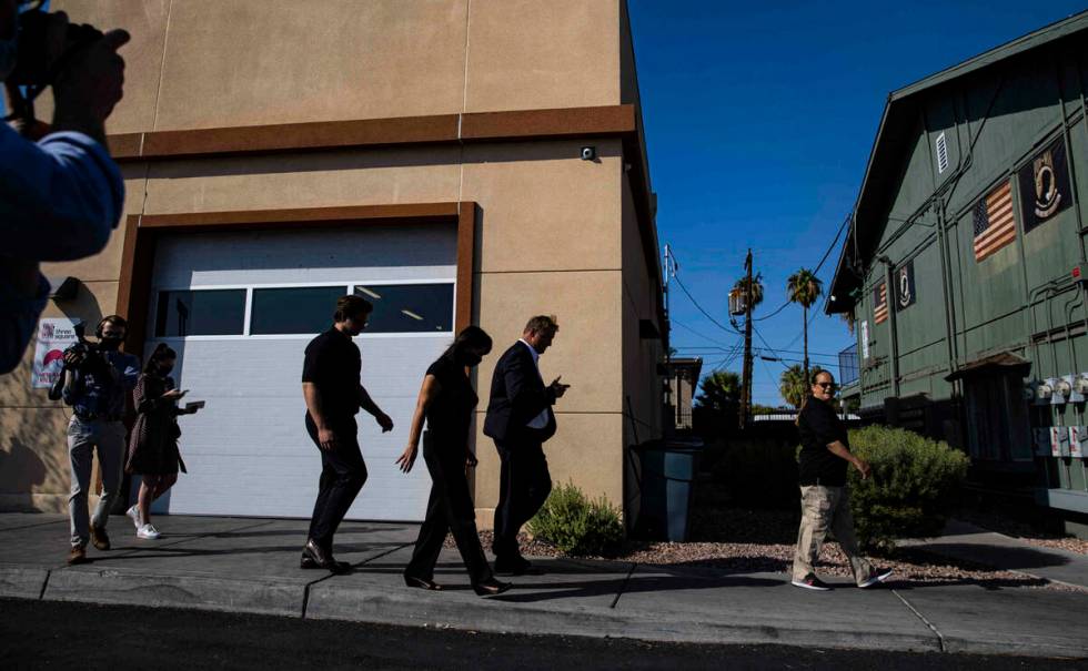 Former U.S. Sen. Dean Heller, second from right, walks with Shannon Kelly, co-founder of Share ...