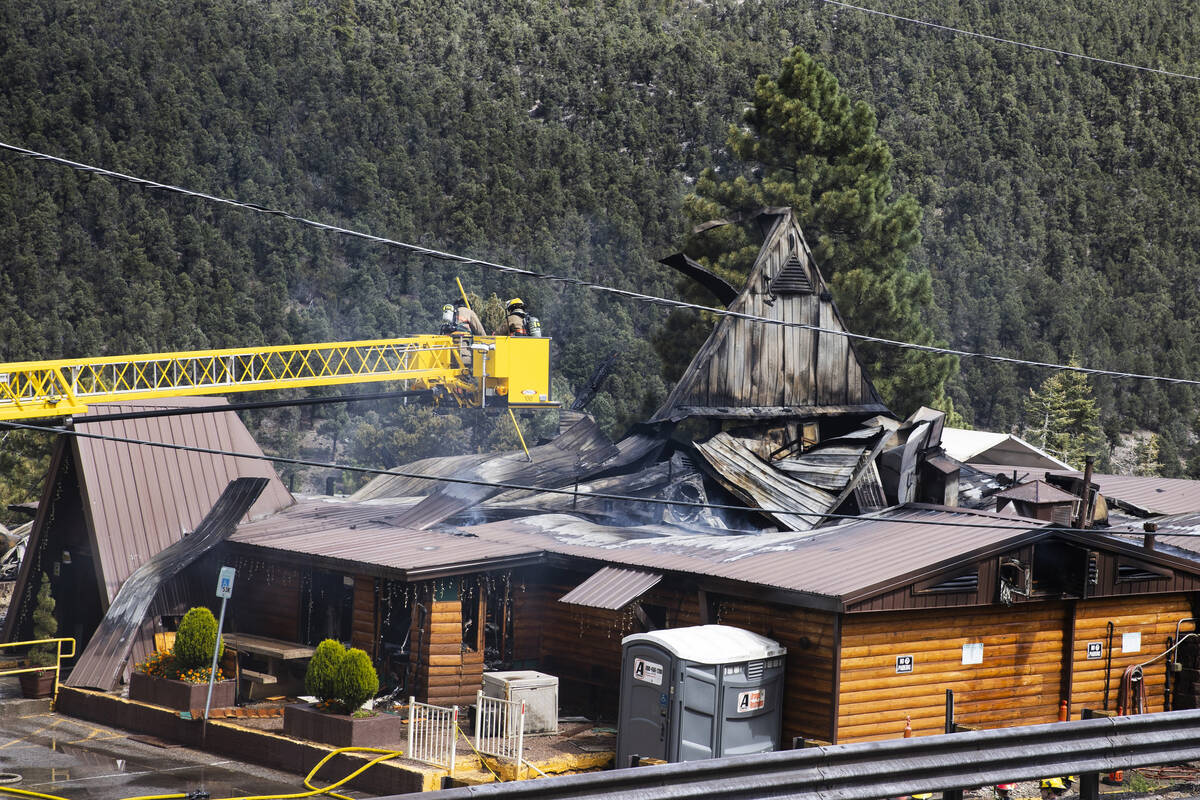 The Clark County firefighters investigate the cause of a fire that damaged Mount Charleston Lod ...