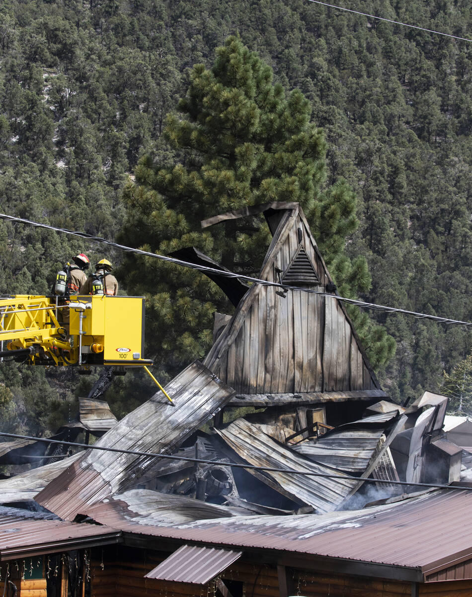 The Clark County firefighters investigate the cause of a fire that damaged Mount Charleston Lod ...