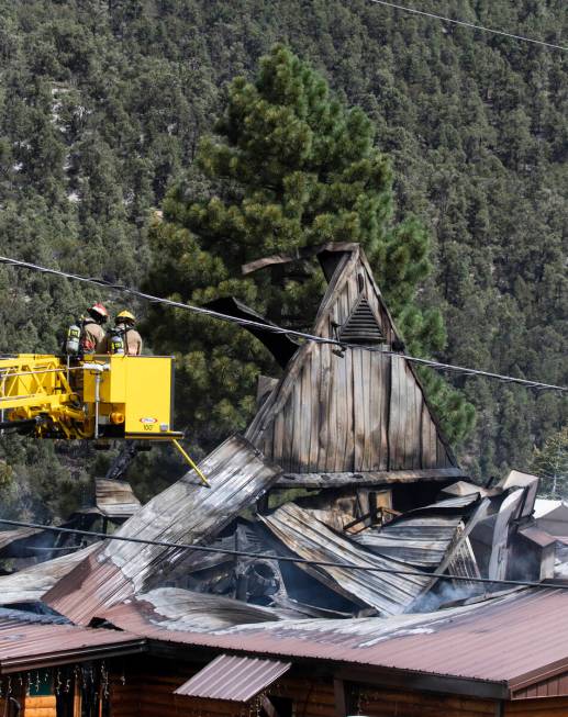 The Clark County firefighters investigate the cause of a fire that damaged Mount Charleston Lod ...