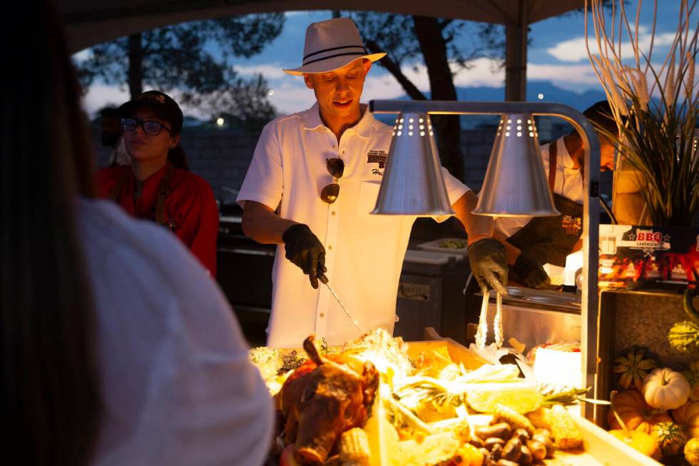 Hristo Velikov of Project BBQ Las Vegas makes a roast pork sandwich for a guest at the Night en ...