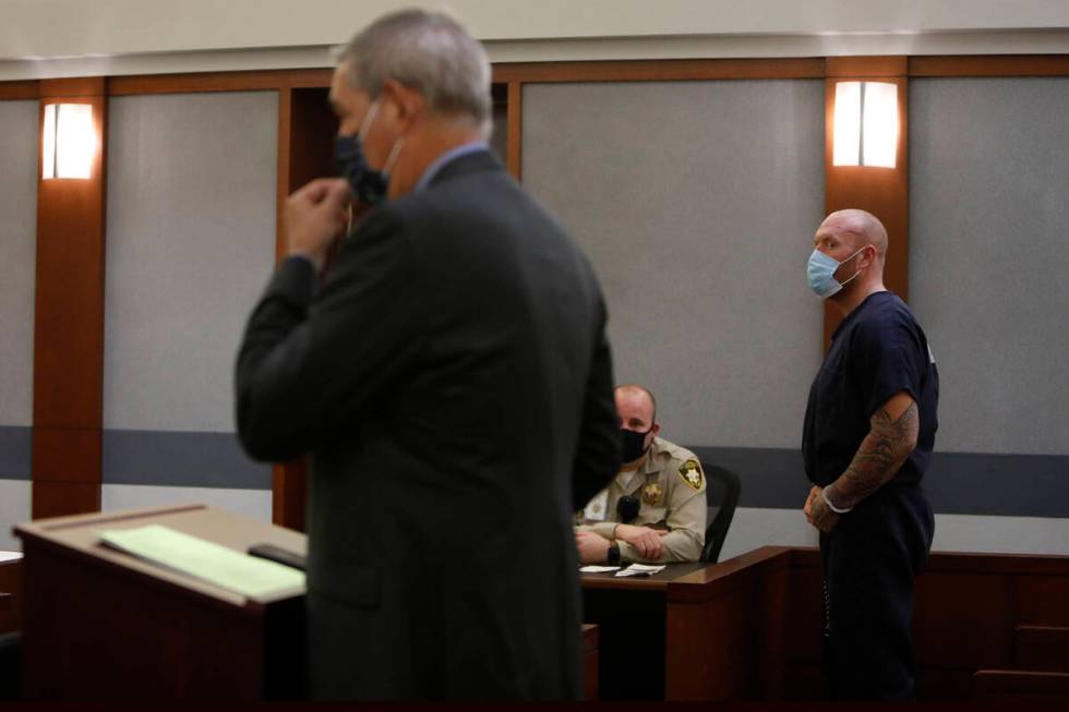 New Haven police officer Robert Ferraro, background listens to his attorney Gabriel Grasso, for ...