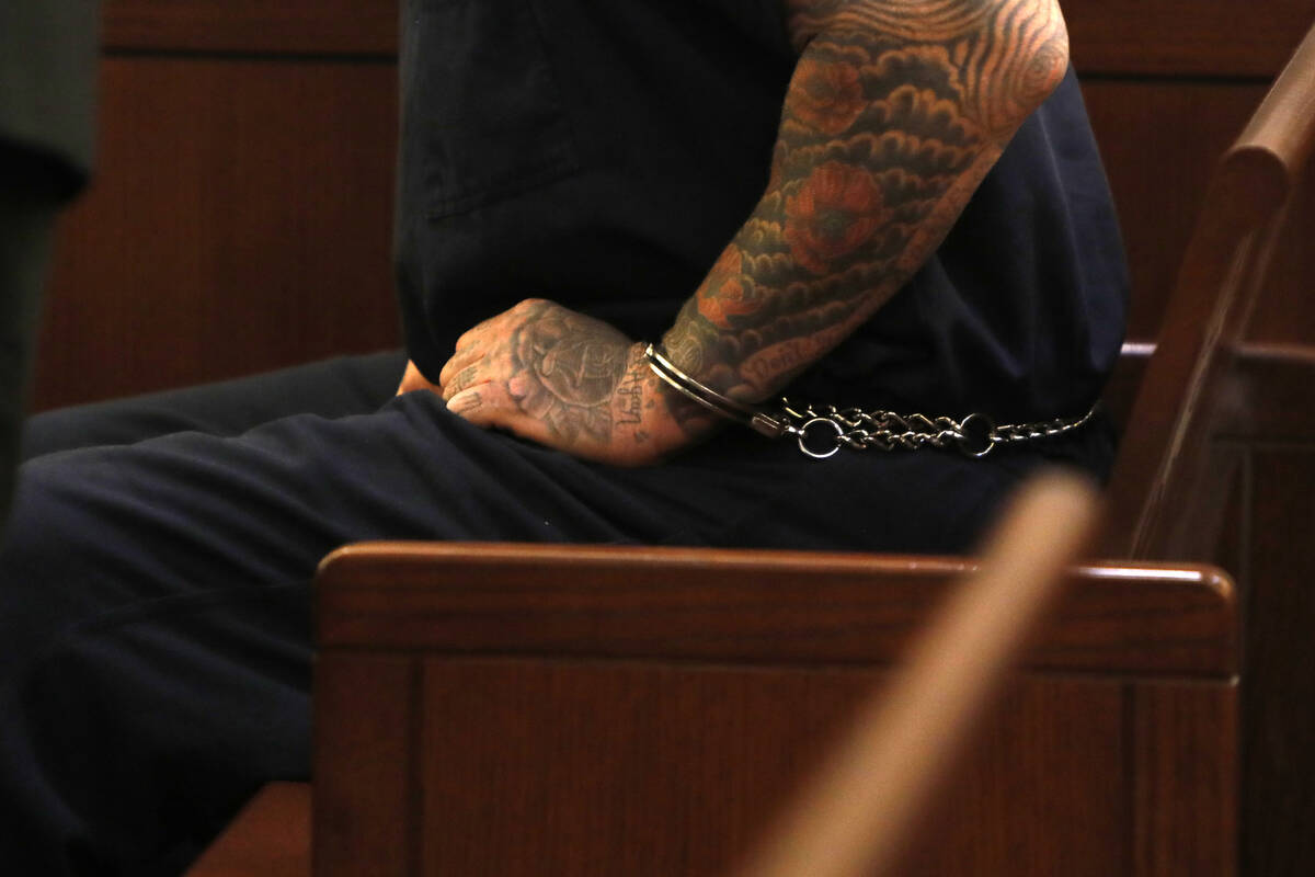 Handcuffed New Haven police officer Robert Ferraro sits in the courtroom for his court hearing, ...