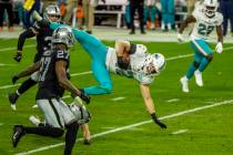 Miami Dolphins defensive back Clayton Fejedelem (42) is airborne from Raiders wide receiver Hun ...