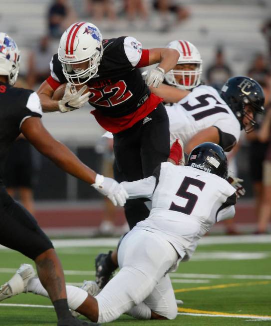 Liberty High School's Brody Clark (22) plays against Faith Lutheran High School's Charlie Stec ...