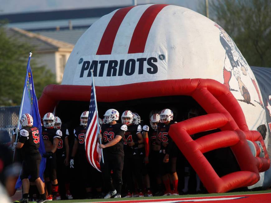 Liberty High School's players are ready to run to the field before a football game against Fait ...