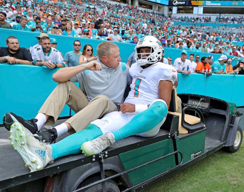 Miami Dolphins quarterback Tua Tagovailoa (1) carted out the field after getting injured in a p ...