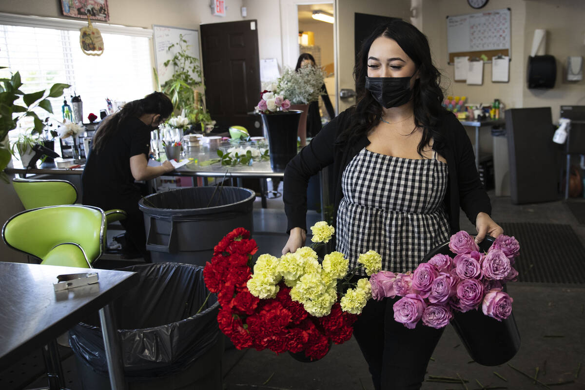 Empty shelves are seen as Theresa Arana, head florist at Chapel of the Flowers, carries out flo ...