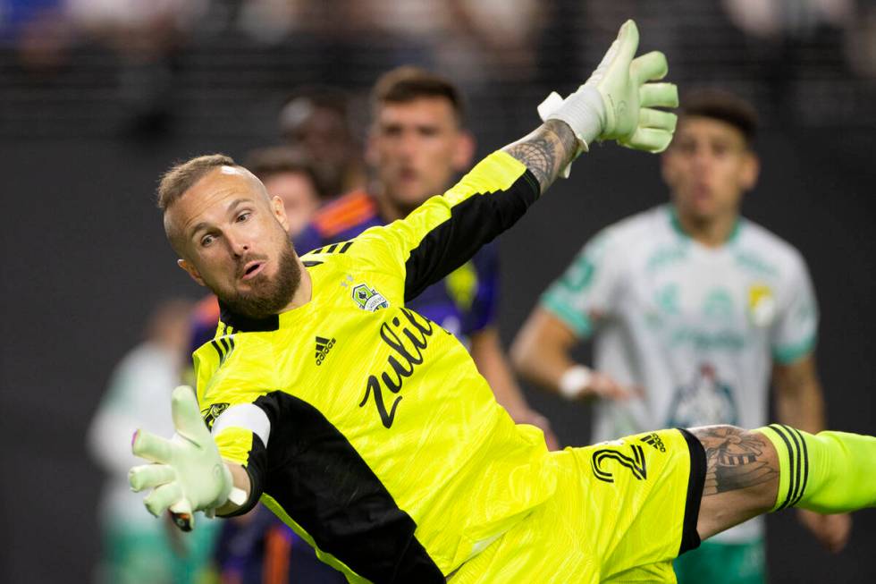 Seattle Sounders goalkeeper Stefan Frei (24) dives to save a shot by Club Len during the League ...