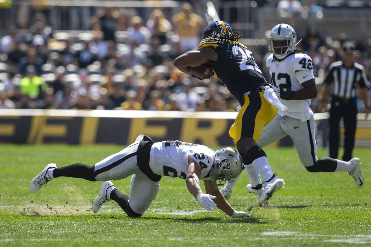 Raiders defensive back Johnathan Abram (24) tackles Pittsburgh Steelers running back Najee Harr ...