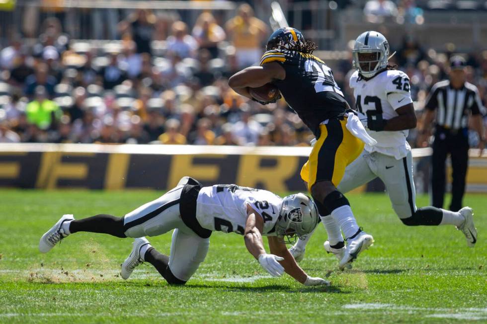 Raiders defensive back Johnathan Abram (24) tackles Pittsburgh Steelers running back Najee Harr ...