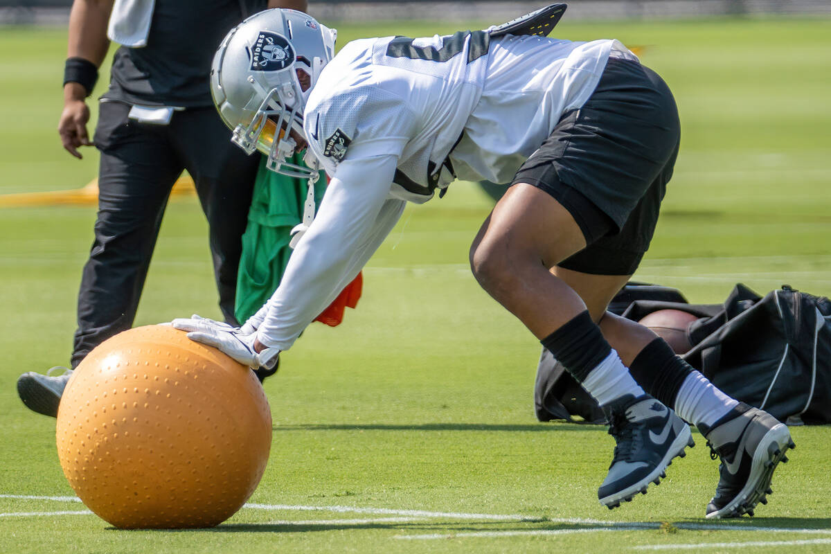 Raiders middle linebacker Denzel Perryman (52) pushes a medicine ball during practice at the In ...