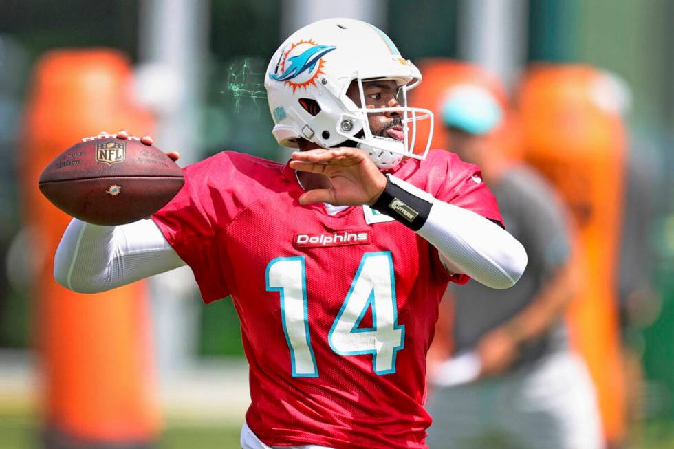 Miami Dolphins quarterback Jacoby Brissett (14) throws during NFL football practice, Wednesday, ...