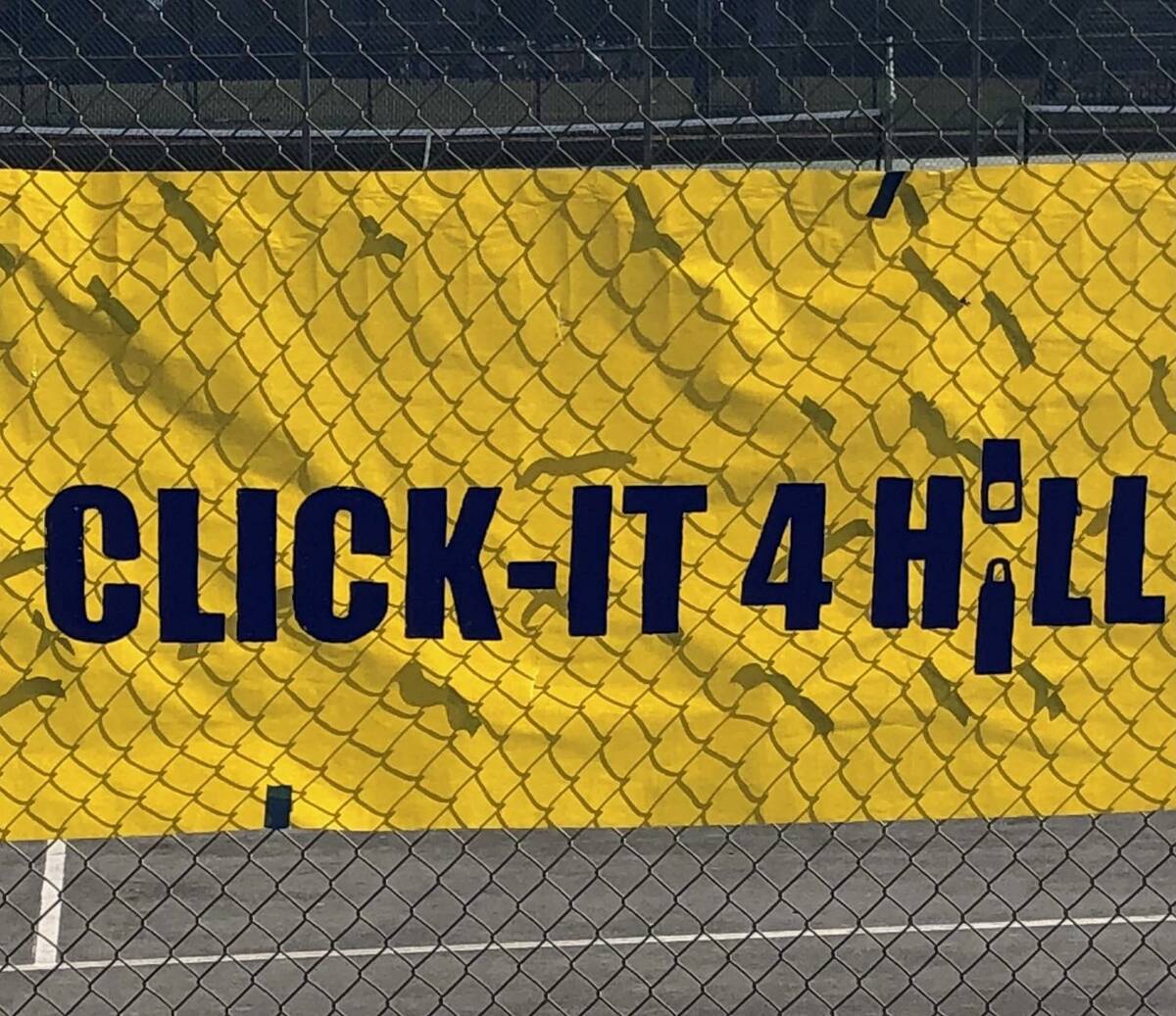 A banner that reads "Click-it 4 Hill is displayed on campus at Shadow Ridge High School. The sc ...