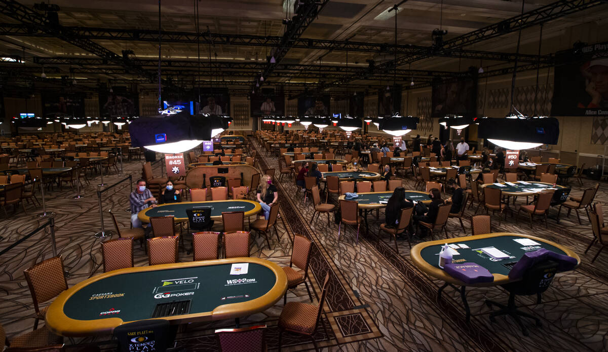 Massage therapists gather near poker tables as they complete paperwork ahead of the World Serie ...