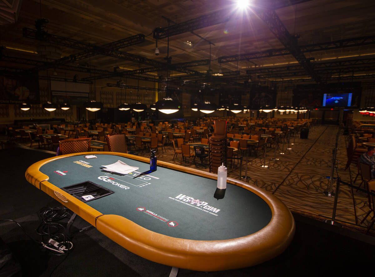 A spotline shines on a poker table onstage in a convention area ahead of the World Series of Po ...