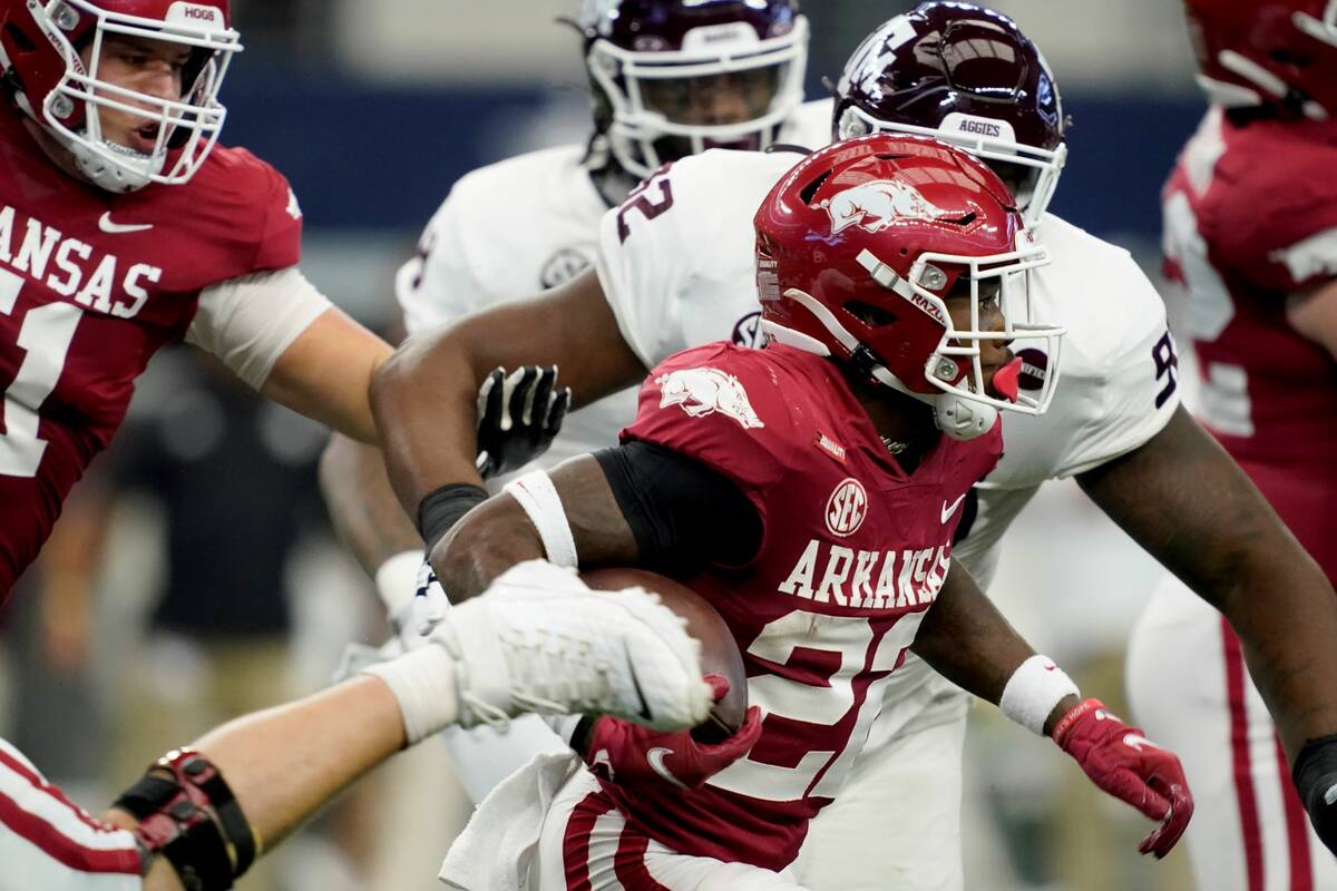 Arkansas running back Trelon Smith (22) carries the ball as Texas A&M defenders give chase in t ...
