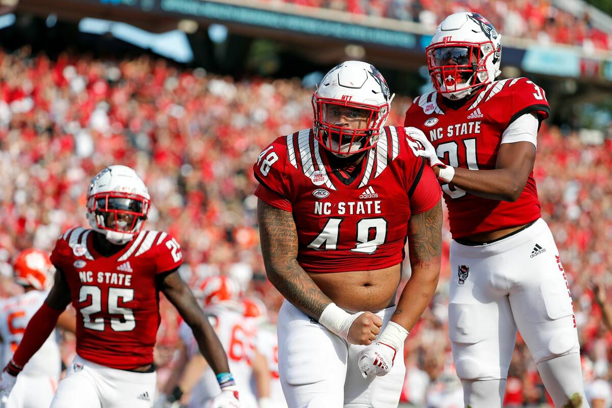 North Carolina State's Cory Durden (48) celebrates a sack with teammate Khalid Martin (21) and ...